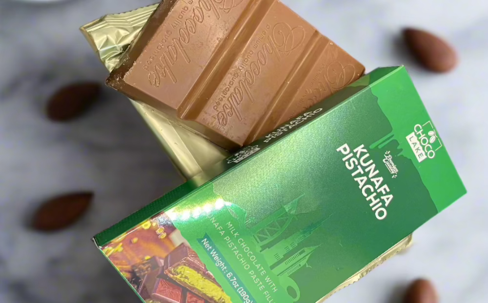 Chocolate bar with green packaging on a light background