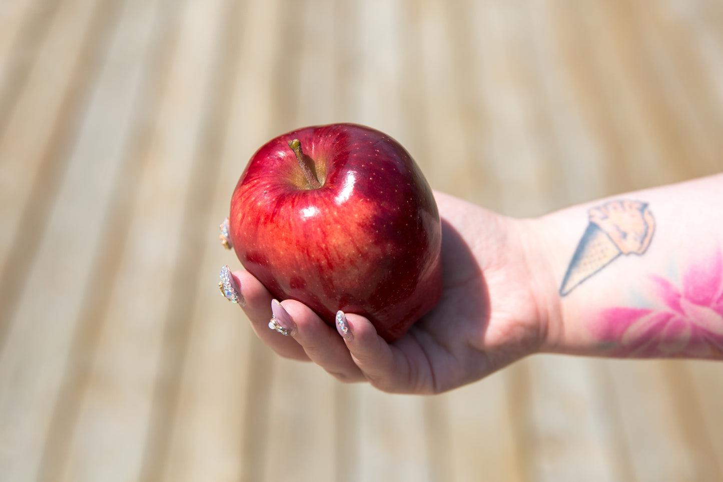 Hand holding fresh red apple