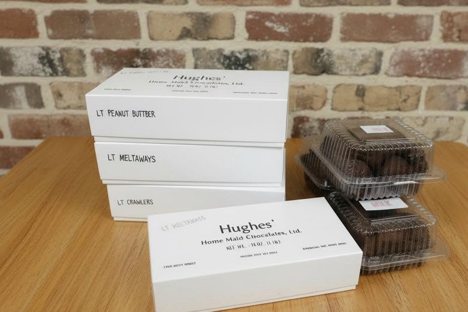 Hughes candy made in osh kosh wisconsin and sold at sweet peas in mayville wisconsin in iconic white one pound boxes, meltaways and seasonal pudding easter eggs